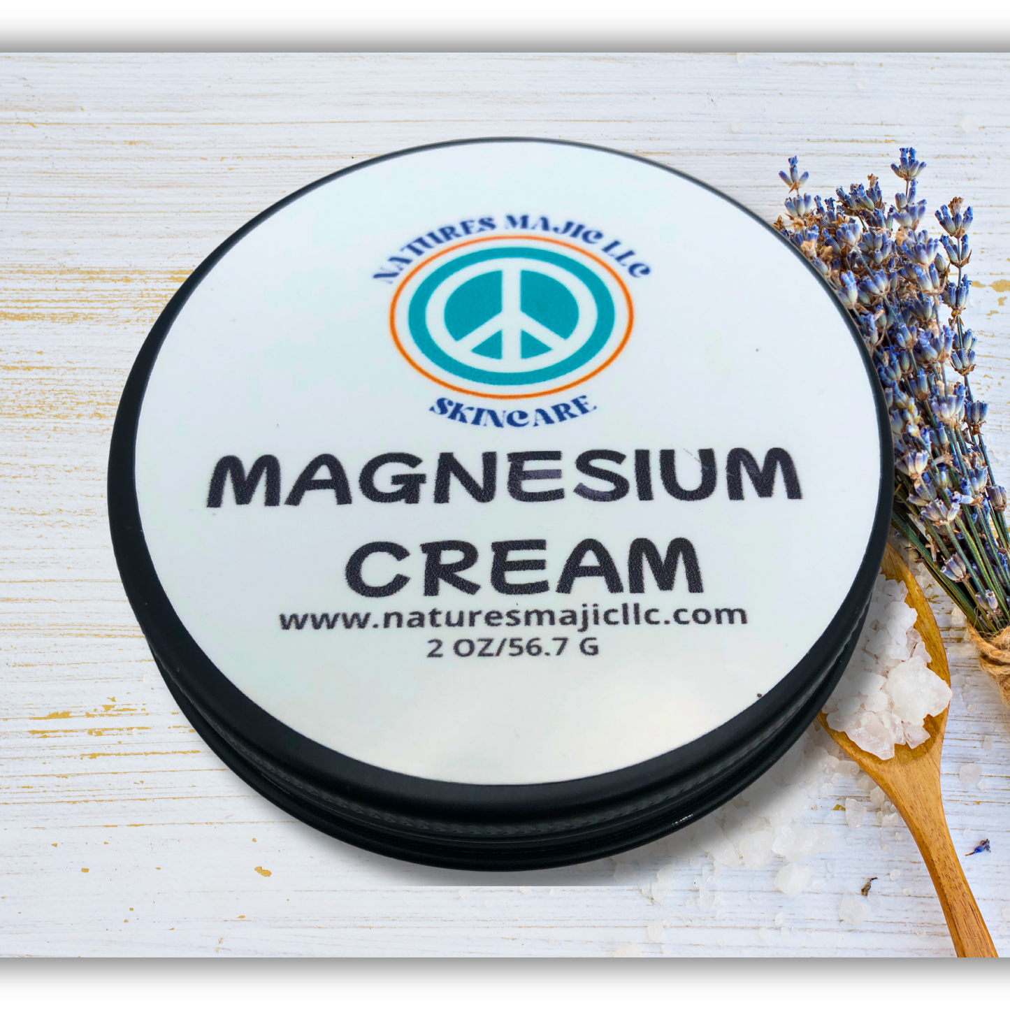 Natural magnesium cream for muscle comfort and restful sleep in a 2 oz jar with lavender and salt background