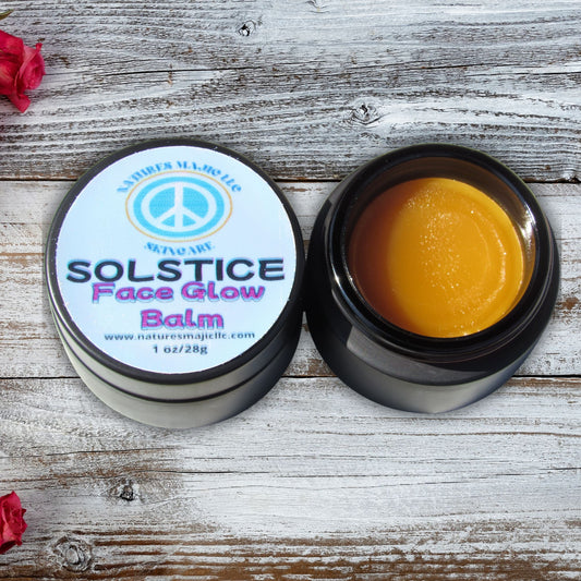 Open black glass jar and lid of Solstice Face Glow Balm for dry, sensitive skin on rustic wooden surface