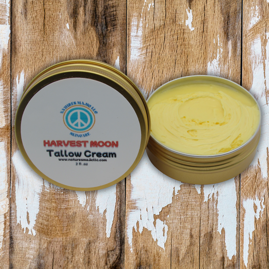 Harvest Moon Tallow Skin Cream in open tin with creamy yellow texture on wooden surface