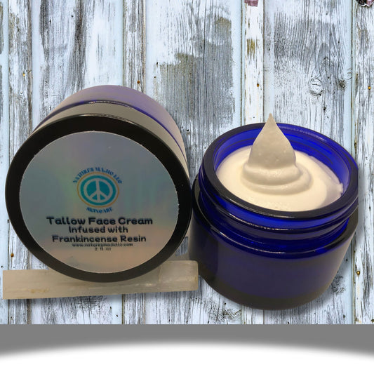 Blue glass jar of Ancient Glow Face Cream with creamy texture, infused with frankincense resin and natural botanicals for skin nourishment and anti-aging benefits.