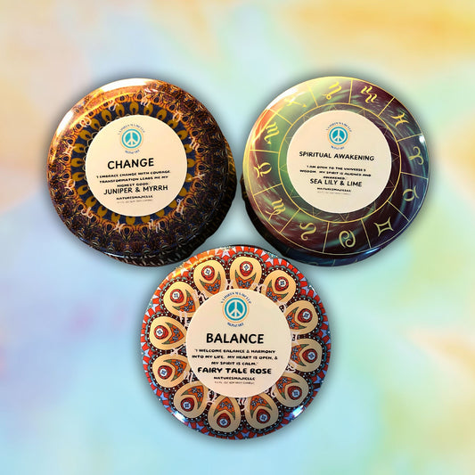 Sacred Manifest Series magickal crystal-infused candles in zodiac tins for balance, change, and spiritual awakening.