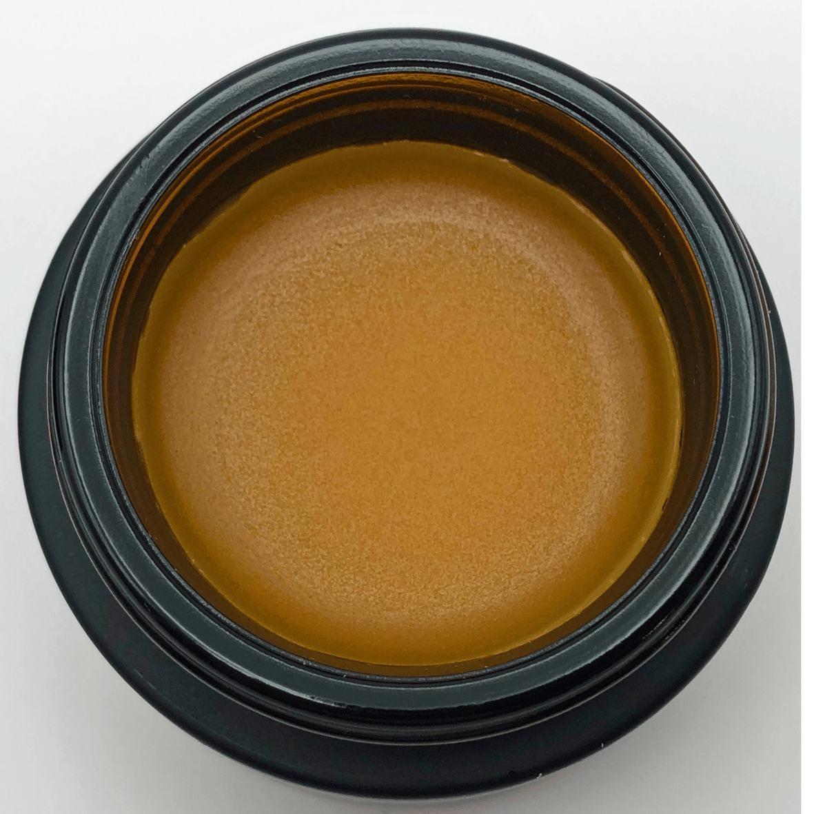 Solstice Face Glow Balm in black glass jar, deeply nourishing, water-free balm for dry sensitive skin with natural emollients.